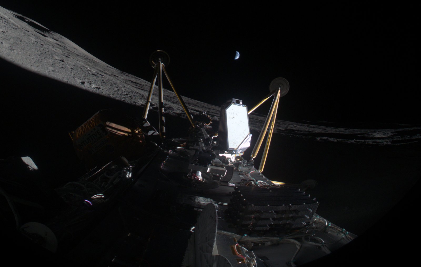 Lander deck and legs seen from its own camera, lunar horizon running diagonally, crescent Earth in a black sky