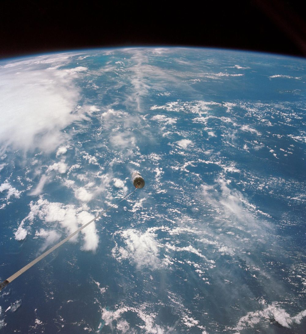 Thin white line running across cloud-covered ocean to a small bright vehicle mid-frame
