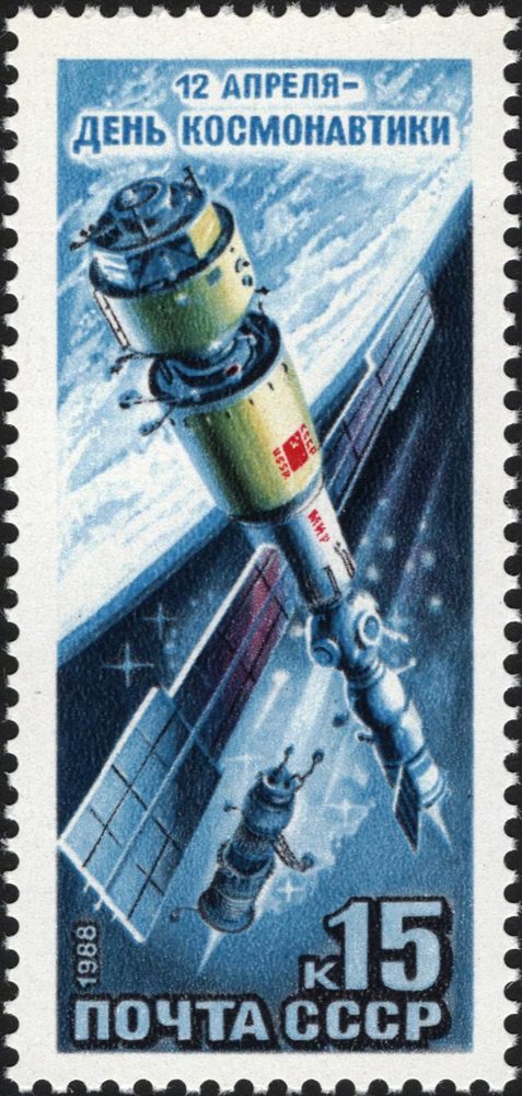 Blue stamp artwork, a cylindrical module large in the foreground and a smaller craft below