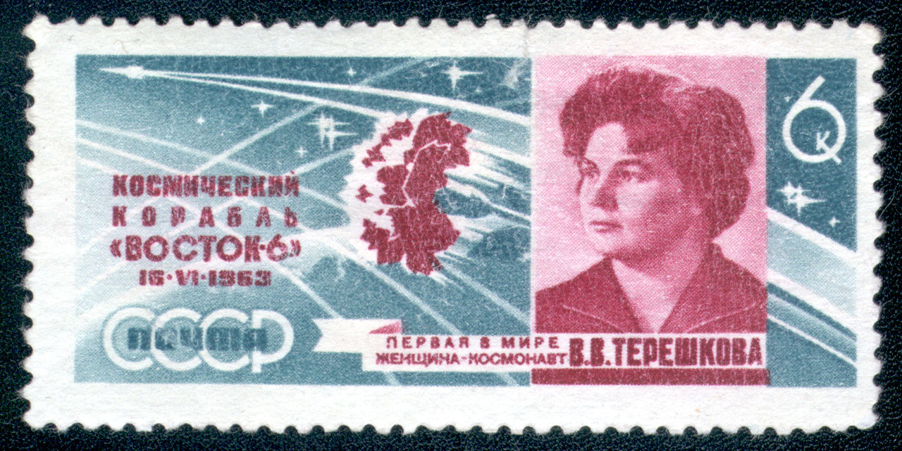 Teal and pink stamp, portrait of a woman beside orbital tracks over a landmass