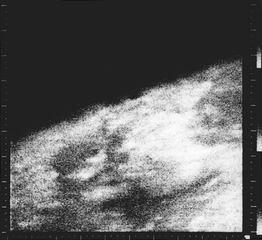 Coarse monochrome frame, a bright curved limb cutting diagonally across black space