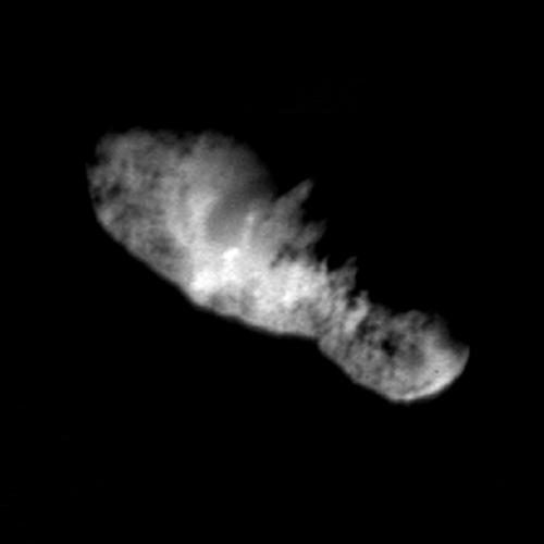 Blurred bright elongated shape, broad at one end and tapering at the other, on black