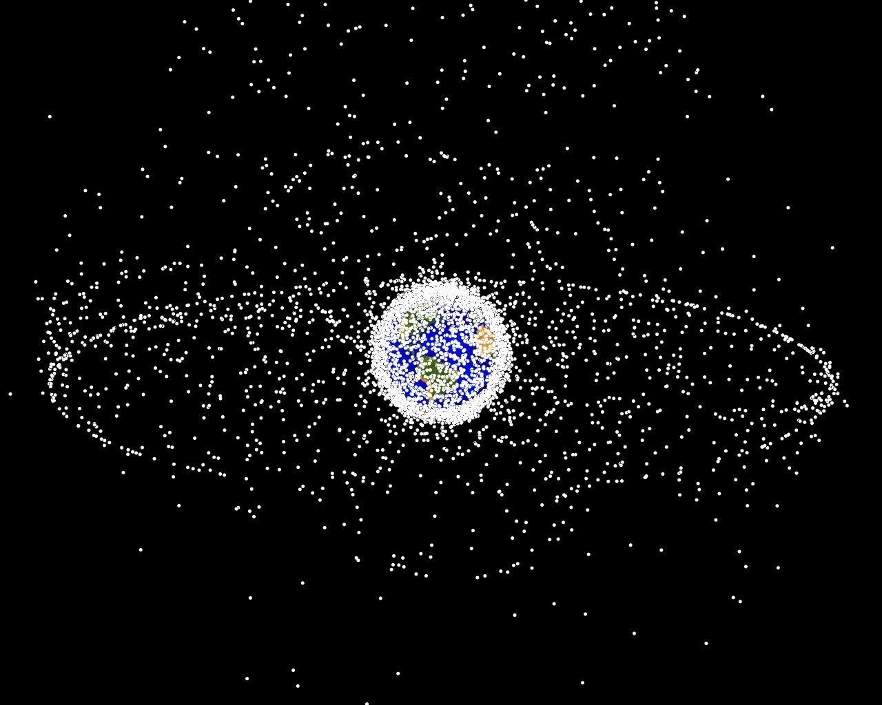Computer plot of Earth surrounded by a dense shell of tracked objects and a distinct outer ring